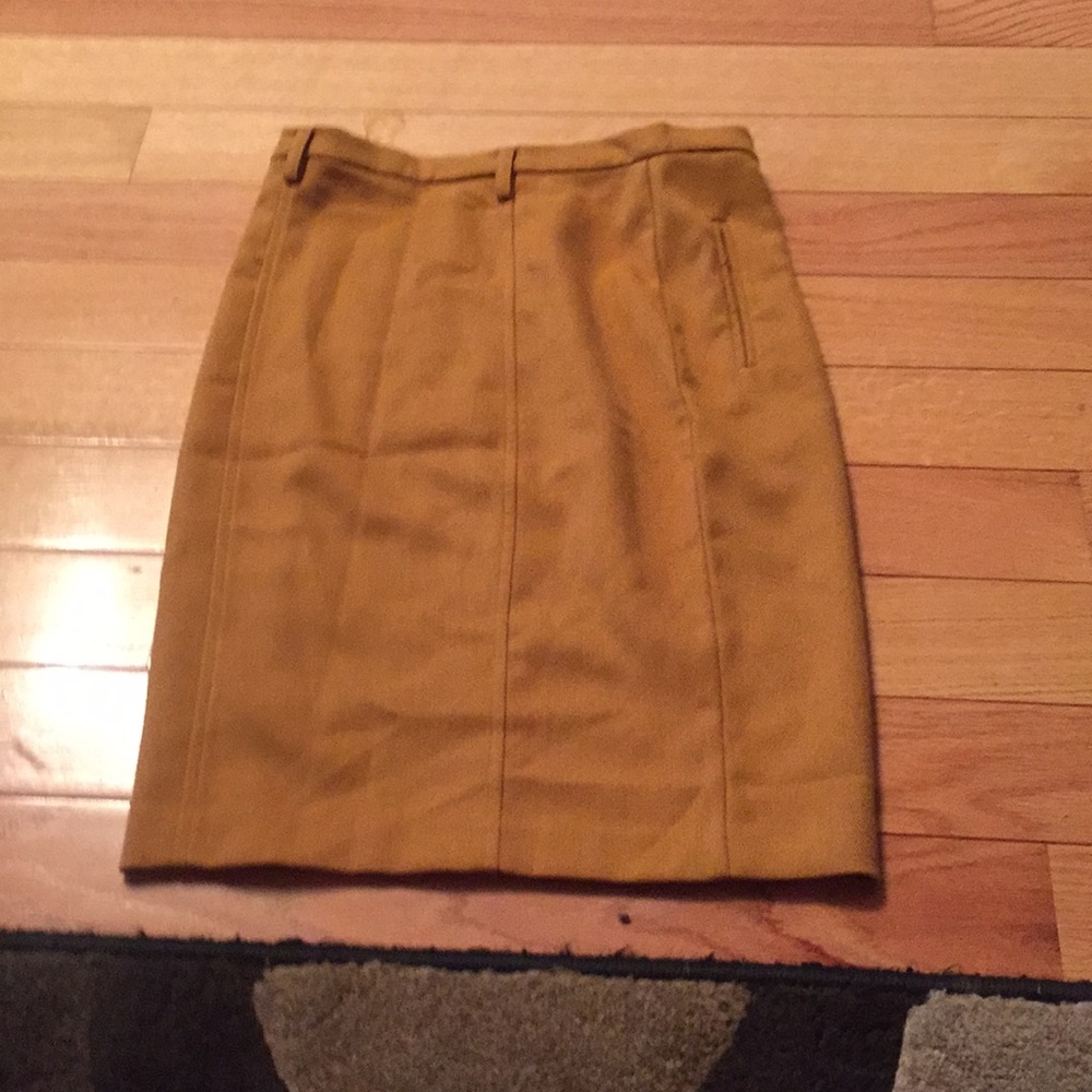 a long mustard color skirt